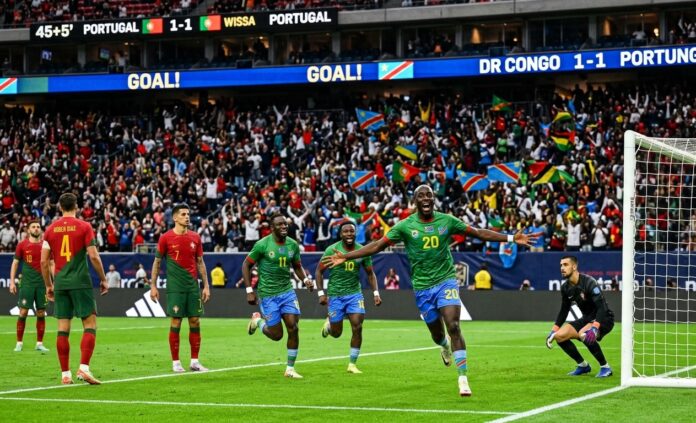 Yoane Wissa Celebrates Historic Equalizer for DR Congo vs Portugal in 2026 World Cup DR Congo forward Yoane Wissa celebrates scoring a historic equalizing header against Portugal during the 2026 FIFA World Cup Group K match, while Portuguese players stand in disbelief.