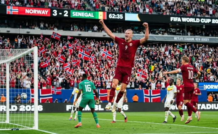 Norway vs Senegal World Cup 2026 Erling Haaland Celebration Erling Haaland in a red Norway kit jumps with arms raised in celebration after scoring against Senegal at MetLife Stadium during the FIFA World Cup 2026.