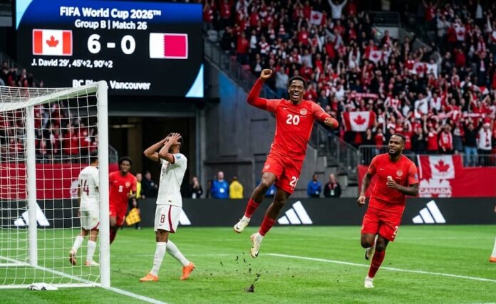 IJonathan David Celebrates Canada's Historic 6-0 Victory Over Qatar at the 2026 FIFA World Cup Canadian forward Jonathan David (number 20) mid-air celebrating a goal, smiling broadly with fists raised, alongside teammate Cyle Larin. In the background, a dejected Qatari player holds his head, while the BC Place stadium scoreboard in Vancouver displays 'Canada 6 - 0 Qatar' for Group B, Match 26 of the FIFA World Cup 2026.