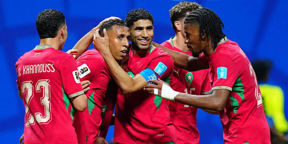 images Morocco vs Haiti World Cup Match Team Goal Celebration Achraf Hakimi and Bilal El Khannouss embrace Soufiane Rahimi during a goal celebration in the Morocco vs Haiti World Cup match.