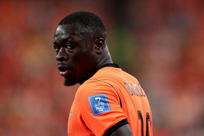 Netherlands forward Brian Brobbey pointing to the sky while celebrating his first-half goal against Tunisia during the 2026 FIFA World Cup.