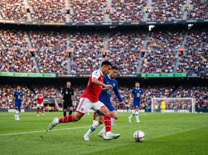 1792263275736 Domestic leagues return as Premier League players battle intensely for possession during a packed stadium weekend match.