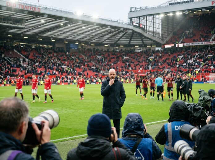 A frustrated Manchester United manager stands in the rain at Old Trafford as the Man United crisis deepens following a home defeat.