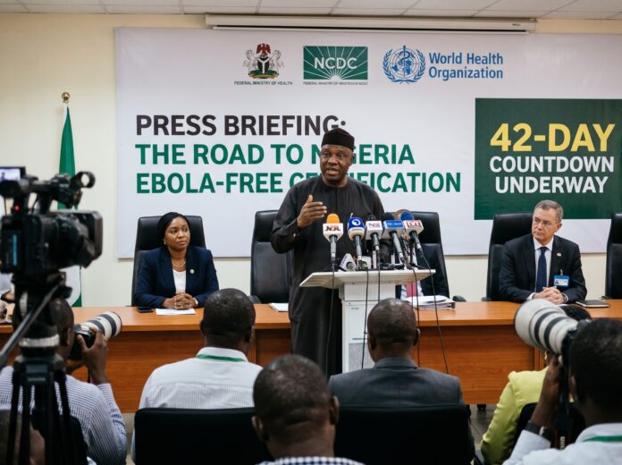 A government health official addresses journalists at a press briefing regarding the 42-day countdown for the official Nigeria Ebola-free certification.