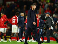 Michael Carrick Under Fire: 3 Brutal Takeaways After Manchester United’s Disjointed Draw Michael Carrick under fire, walking off the pitch looking dejected with Manchester United players in the background.