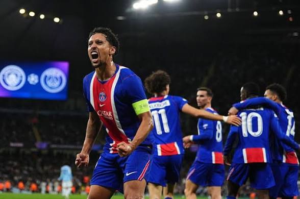 images (14) PSG captain Marquinhos passionately celebrating a goal with clenched fists, alongside teammates in the background during the match against Manchester City.
