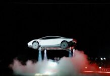 Tesla Flying Sports Car: Historic Elon Musk Reveal Shocks the World Tesla flying sports car hovers in mid-air above plumes of smoke during Elon Musk's live demonstration.