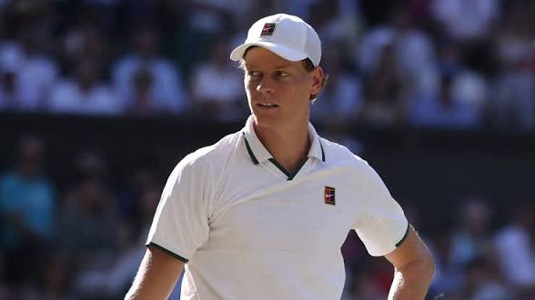 images (3) Jannik Sinner wearing a white cap and polo shirt during a tennis match