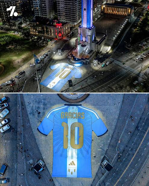 images (4) Aerial view of a massive illuminated Argentina number 10 jersey reading 'Gracias' projected onto a plaza celebrating the Lionel Messi final Argentina match.